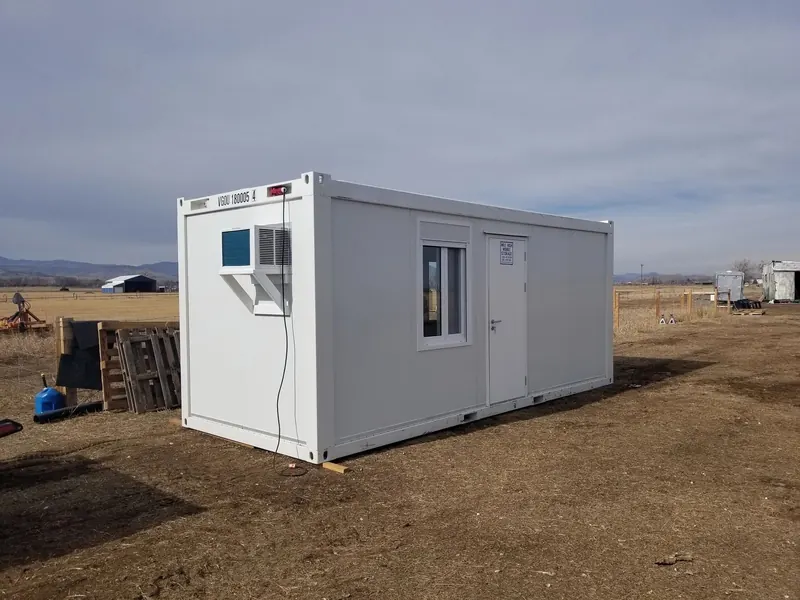 A white 8x20 mobile office on a dirt job site